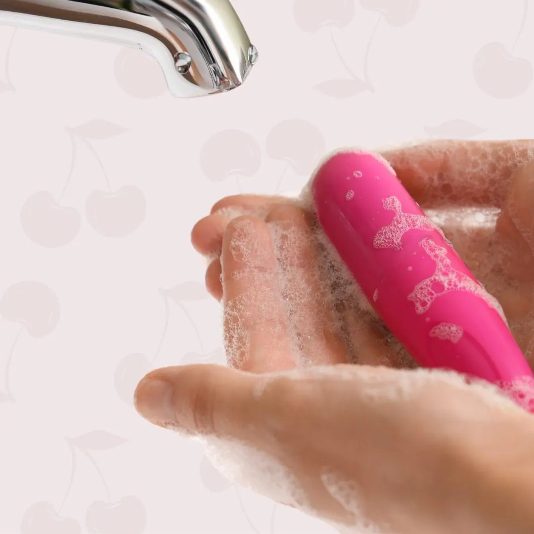Close-up of bullet vibrator being washed under tap