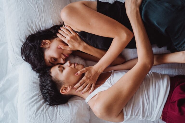 Couple laying in bed and embracing tenderly